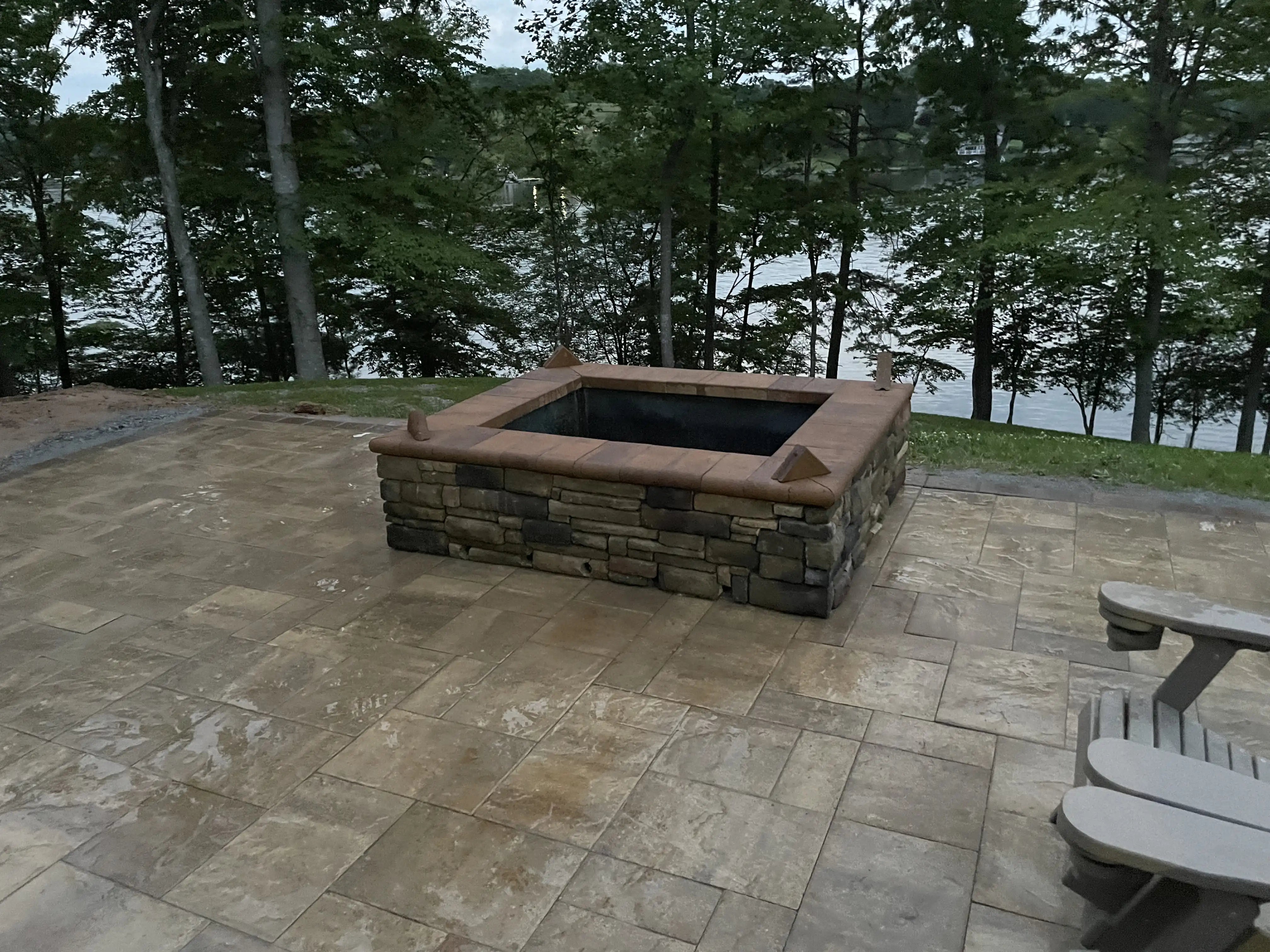 Custom stone fire pit overlooking a lake in the Roanoke area