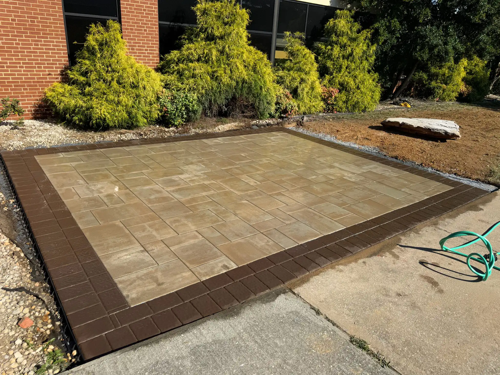 Completed outdoor living space with patio and fire feature