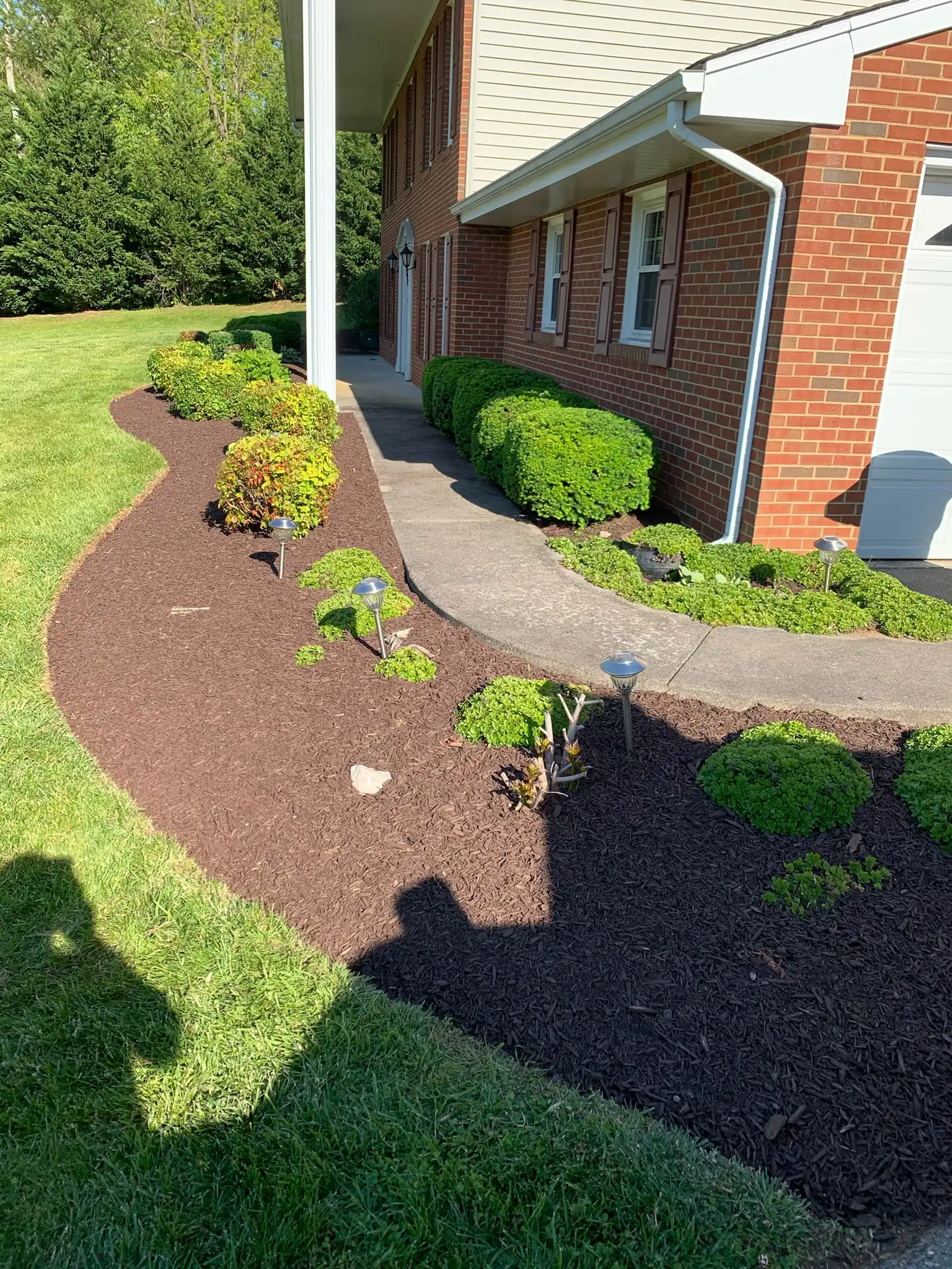 Freshly installed landscape beds and lawn on a residential property