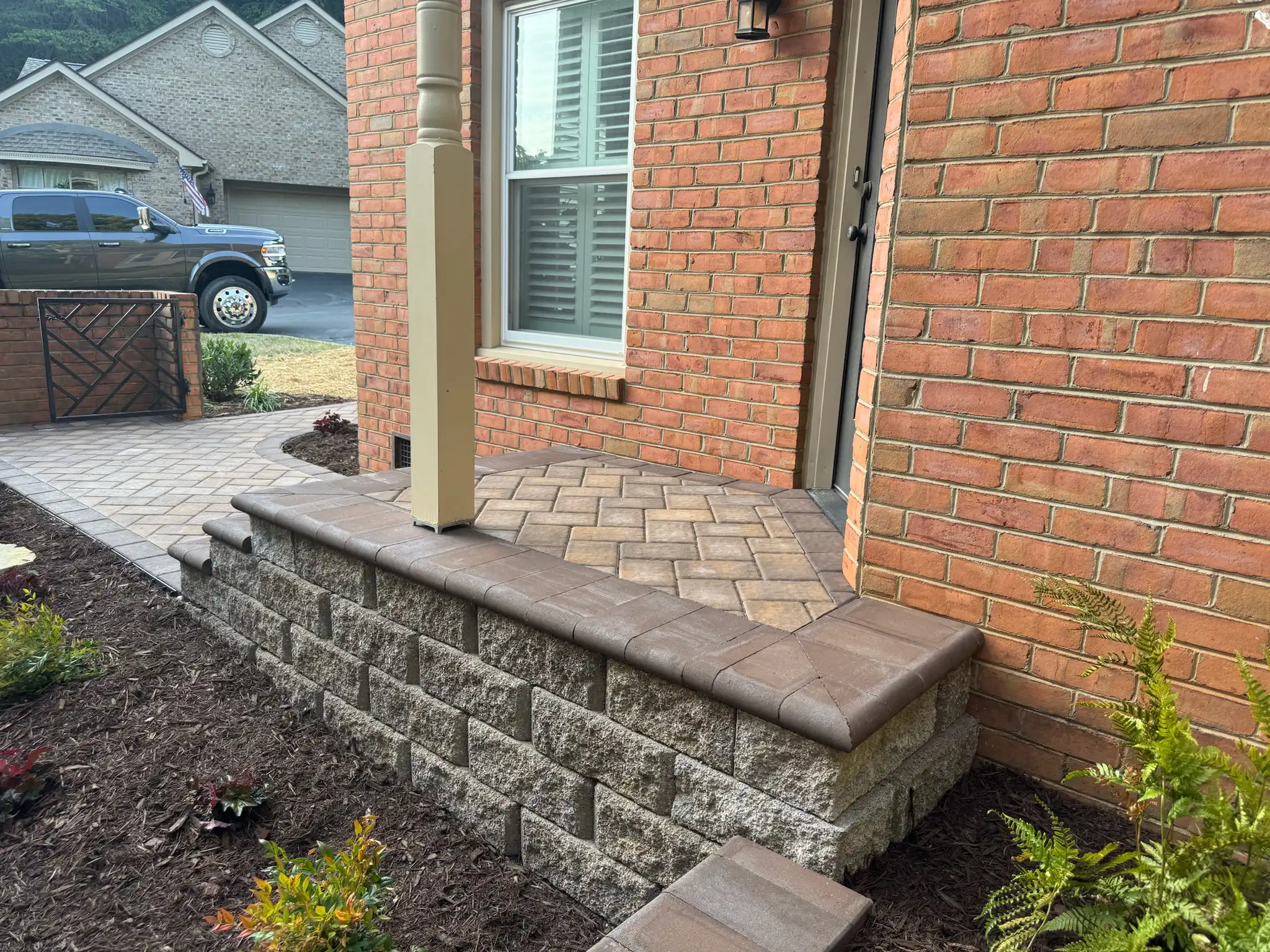 Paver steps connecting two levels of a landscaped yard
