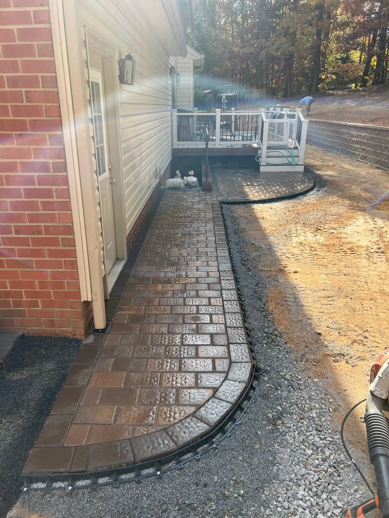 Paver walkway installation along a residential property