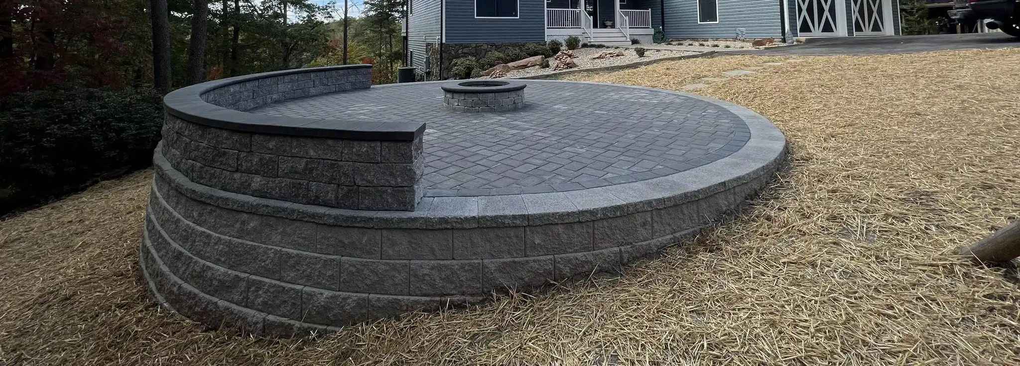 Circular paver patio with sitting wall and fire pit